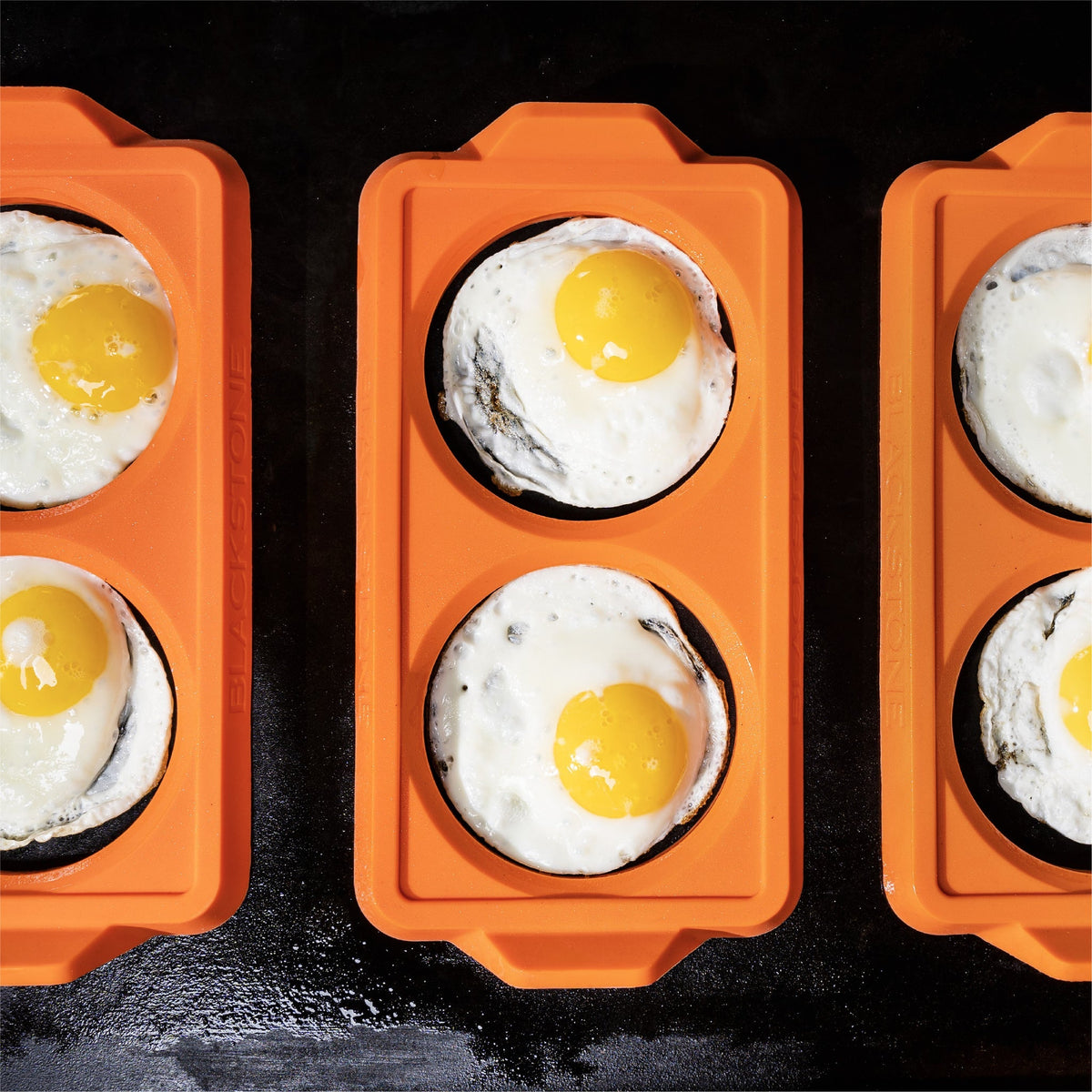 Blackstone 2 Section Silicone Egg Ring Trays, 3 Pack - Orange - three trays of eggs