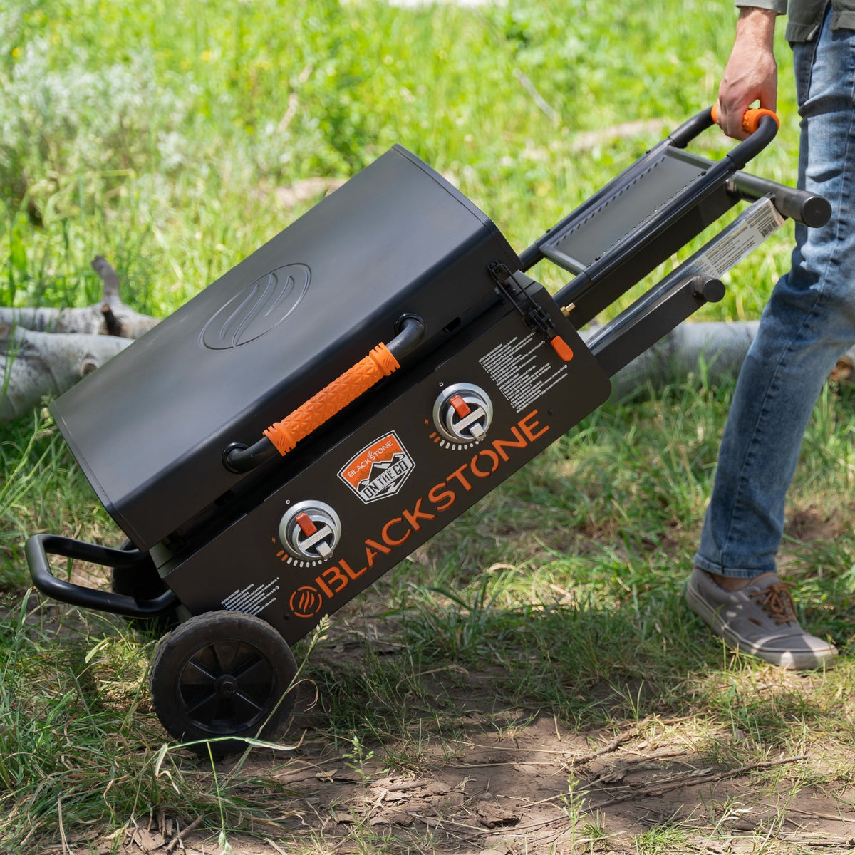 Blackstone On The Go 22" Omnivore Gas Griddle with Hood and Flexfold Legs - Black - rolling the folded griddle