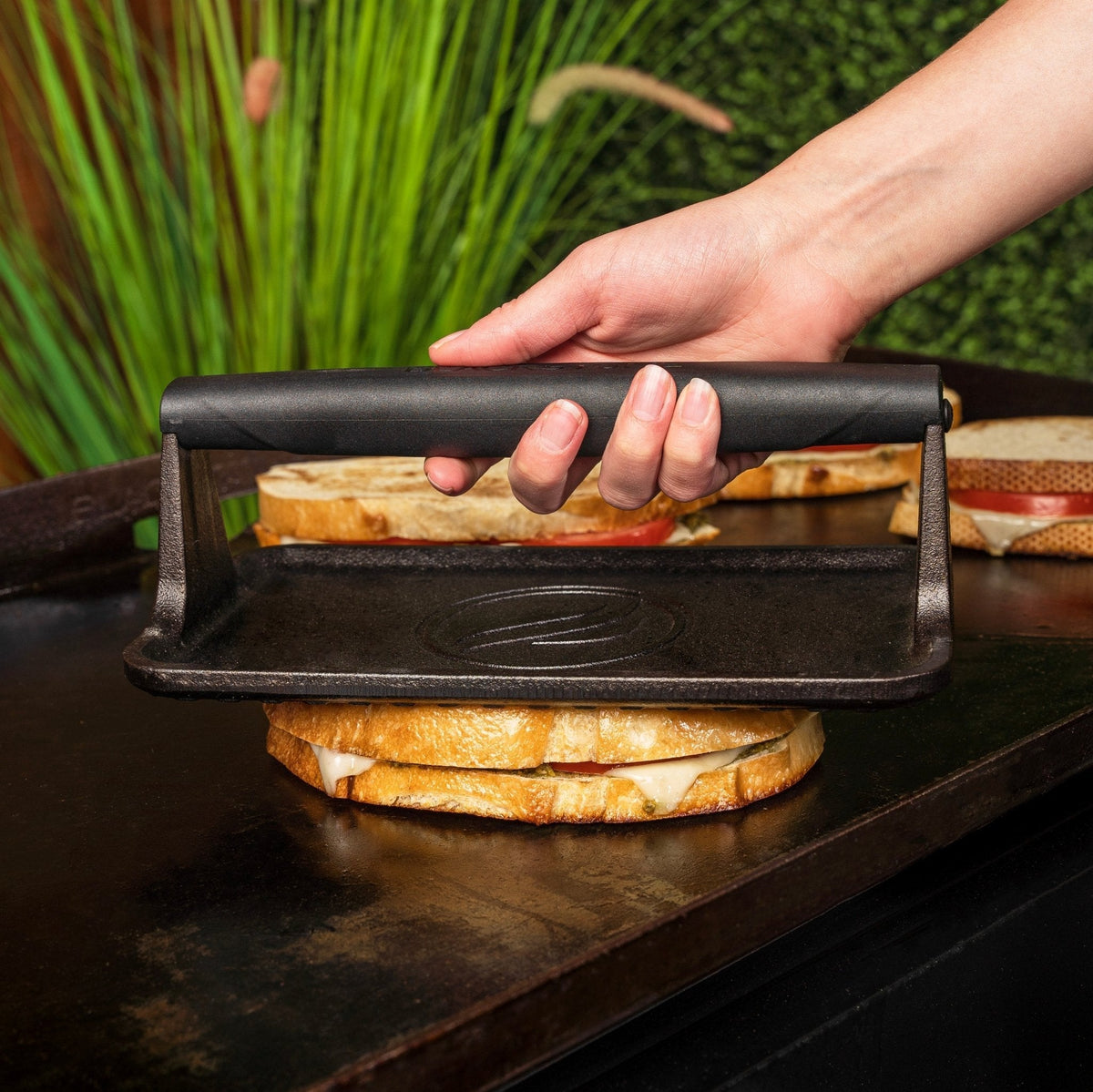 Blackstone Medium Cast Iron Griddle Press - pressing a sandwich flat