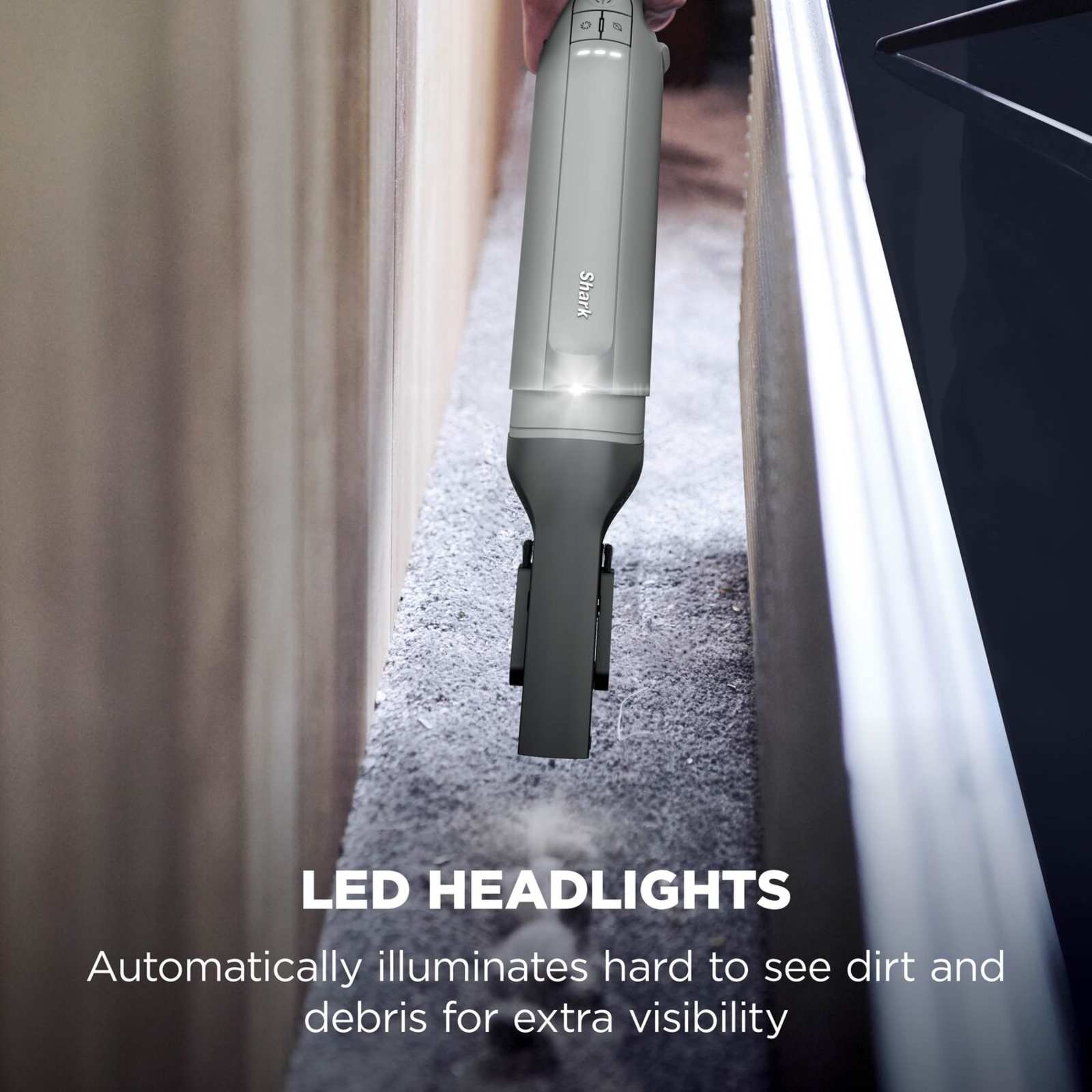 Shark WandVac Deluxe Pet Pro LED headlight illuminated while cleaning a stair edge, captioned 'LED headlights'