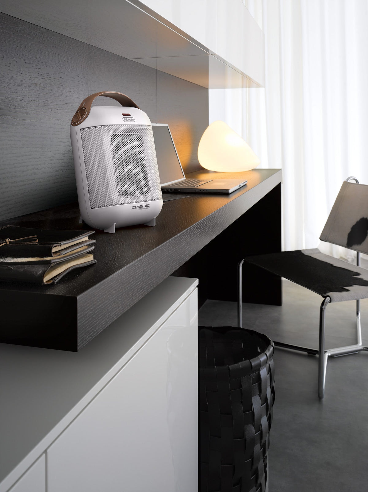 De'Longhi Capsule 1800W Fan Heater - White - beside a home office desk