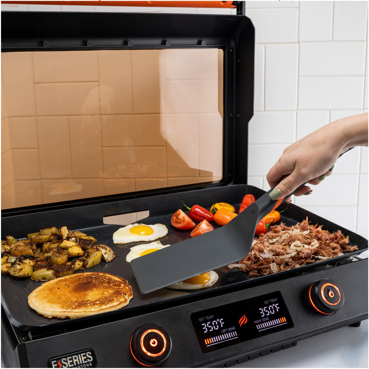 Blackstone E-Series 4 Piece Nylon Griddle Kit - tongs on the E-Series griddle