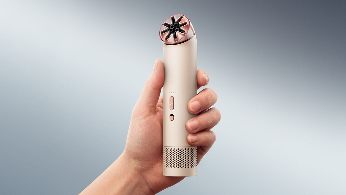 Dyson HushJet Mini Cool Portable Fan - Stone/Blush - held in the hand