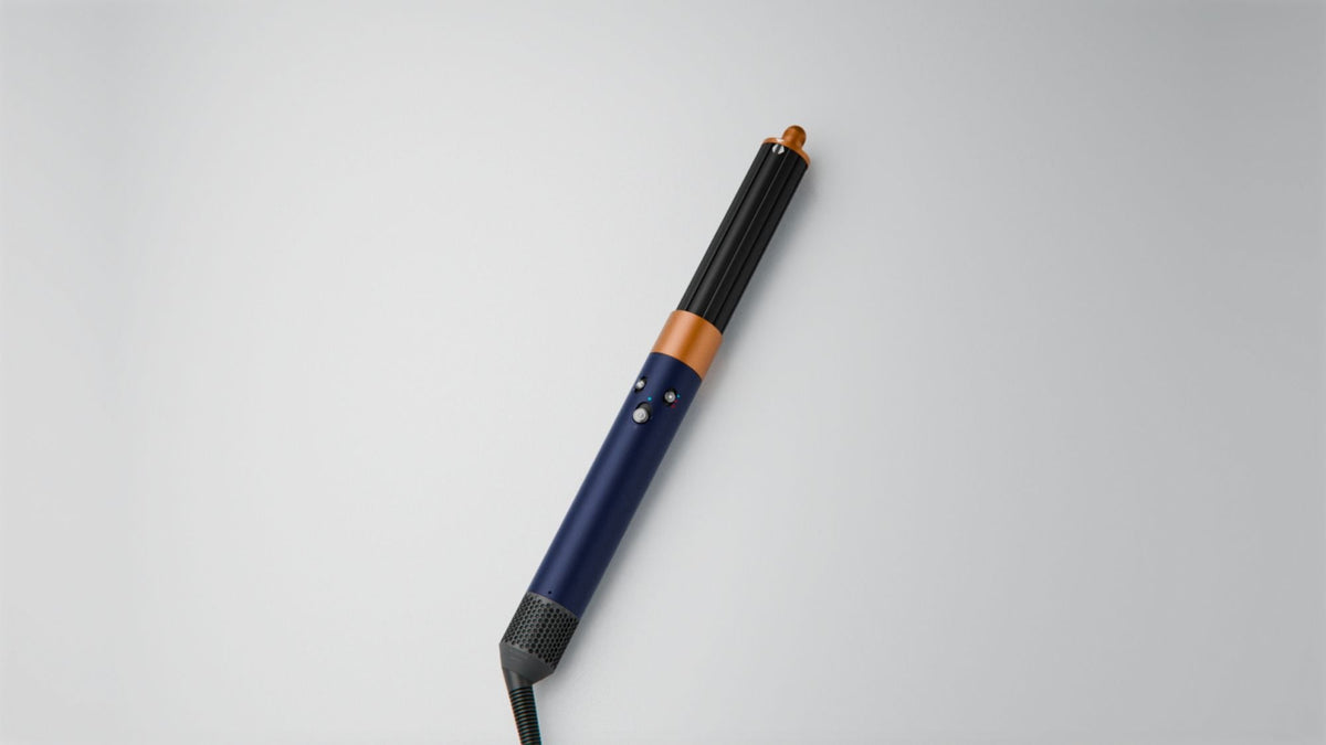 Dyson Airwrap Origin Multi-Styler and Dryer - Prussian Blue/Rich Copper - on a dressing table