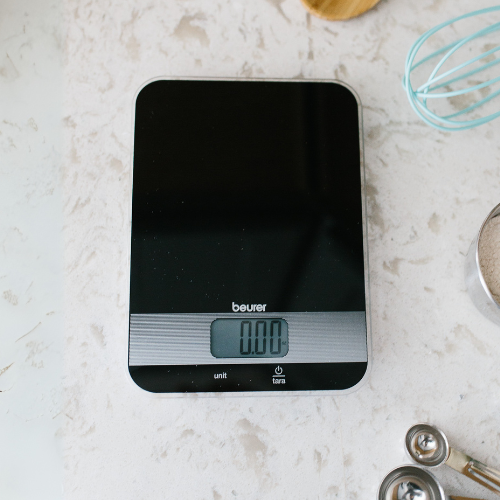 Beurer KS 19 Kitchen Scale Black, top-down view on kitchen counter with measuring spoons