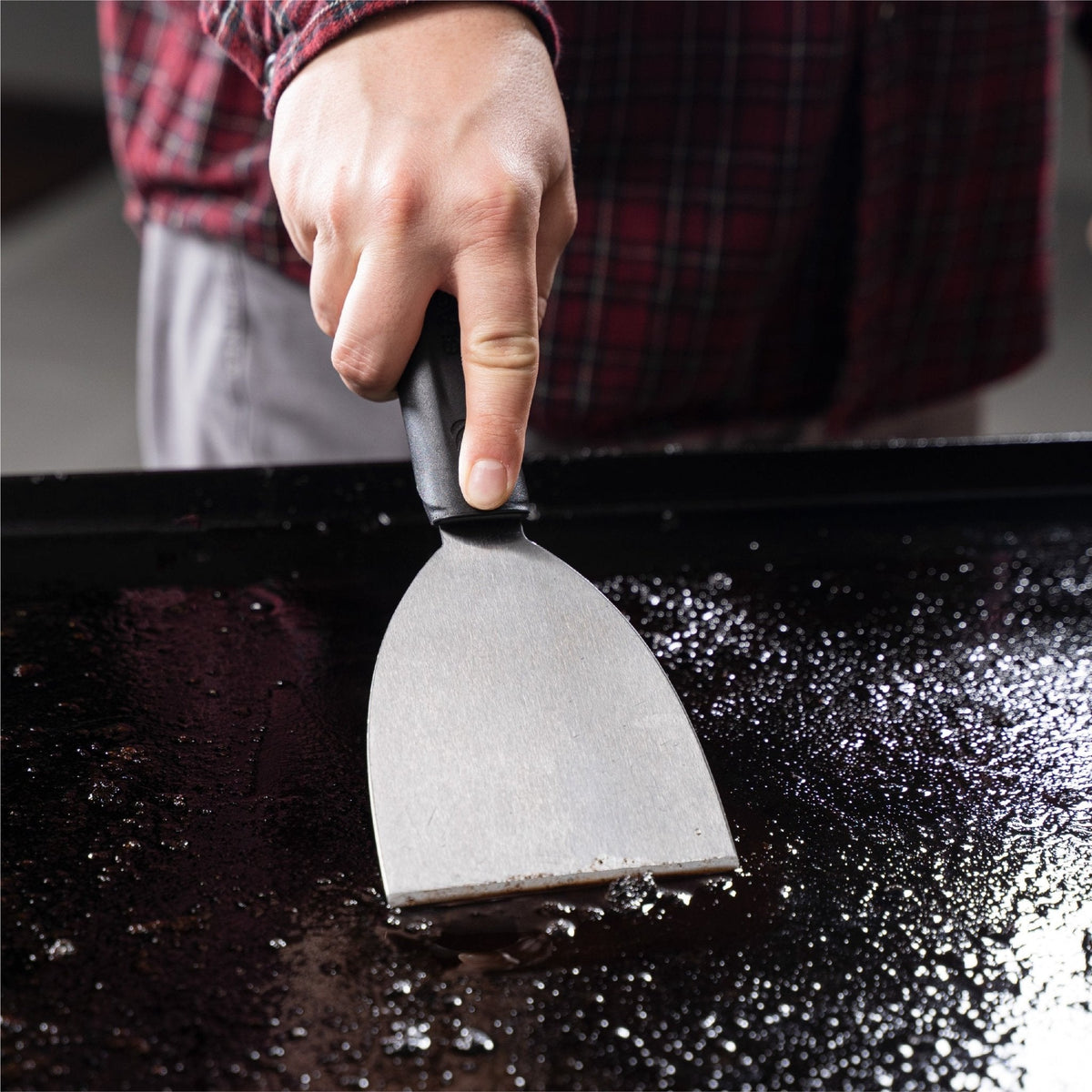 Blackstone 8 Piece Griddle Cleaning Kit - scraper in use