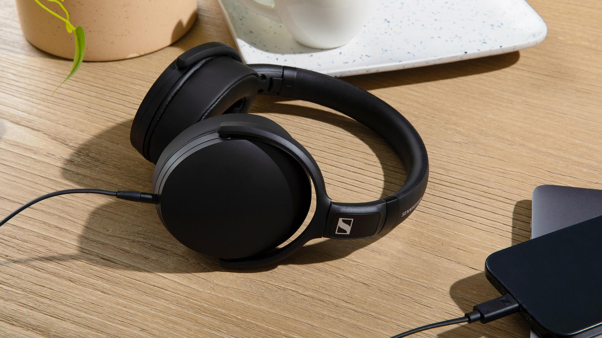Sennheiser HD 400U USB-C Headphones Black — lifestyle desk scene with phone