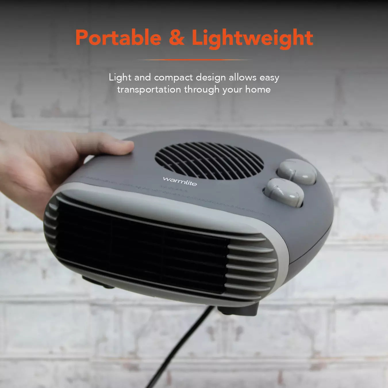 Warmlite WL44004DT flat fan heater in dark titanium, plugged in on a windowsill